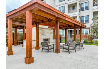 outdoor covered patio with fireplace at Reveal at Onion Creek apartments